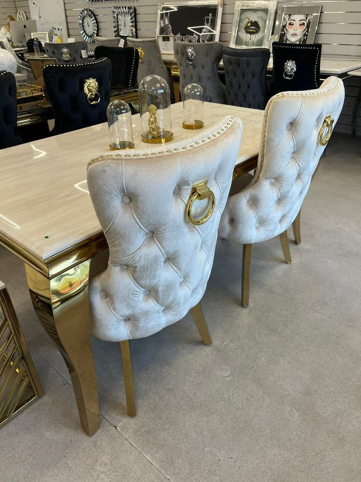 Louis Gold Cream Marble Dining Table With Shimmer Gold Ring Knocker Dining Chairs - Belmont Interiors